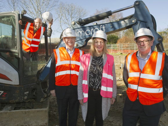 Paul Mitchell on a digger with Mark Austen, Natalie Murphy and Nigel Allen, from Rollalong, at the Mitchell Court groundbreaking